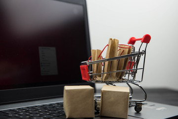 Shopping cart with purchases - packages and boxes. Online shopping and sale concept.