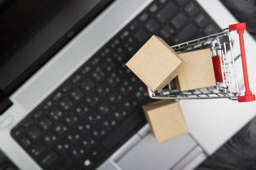 Shopping cart with purchases - packages and boxes. Online shopping and sale concept.