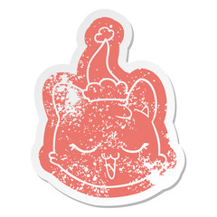 cartoon distressed sticker of a cat face wearing santa hat