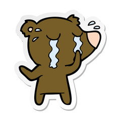 distressed sticker of a cartoon bear crying