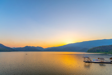 Fototapeta premium Landscape of sunset on Mountain In the reservoir Sukhothai,Thailand