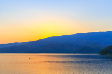 Fototapeta premium Landscape of sunset on Mountain In the reservoir Sukhothai,Thailand