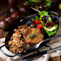 Pork steak with mushrooms and buckwheat groats and mango salad