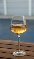 A glass with a golden colored liquid isolated against an out of focus background image with copy space in portrait format