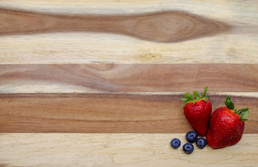 Strawberries and Blueberries on Wood
