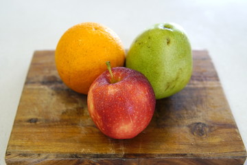 Naklejka na ściany i meble orange pear and apple prepared for a fresh and nutritious salad