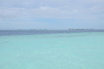 White sand turquoise water against the background of the blue sea