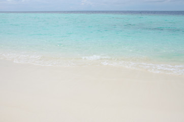 White sand turquoise water against the background of the blue sea