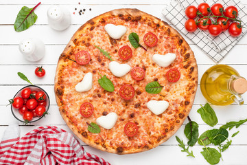 Hot Italian Pizza With Heart Shaped Mozzarella, Tomatoes, Cheese And Green Salad Leaf. Top View. Food Flat Lay