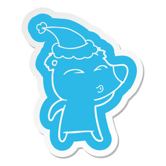cartoon  sticker of a whistling bear wearing santa hat