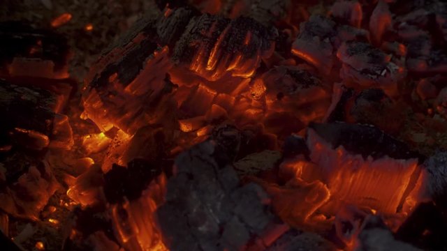 A warm and moody feel. The light seems to dance in the hot coal that glows from a previous fire.