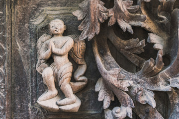 Archaeological, Close Up of carved art figures on old wood carvings on the wall temple at Shwe Nan Daw Kyaung (Golden Palace Monastery) in Mandalay, Myanmar