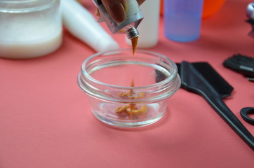 Barber shop set with hair dye, hairbrush, scissors, spray and brush on pink red background