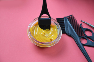 Barber shop set with hair dye, hairbrush, scissors, spray and brush on pink red background