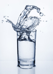 Fototapeta na wymiar Glass with splashes of water. Splashing water. Copy space.