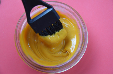 Barber shop set with hair dye, hairbrush, scissors, spray and brush on pink red background
