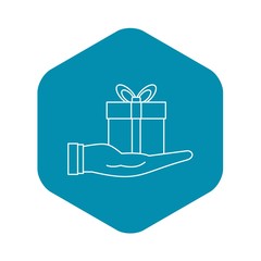 Gift box in hand icon. Outline illustration of gift box in hand vector icon for web design