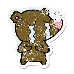 distressed sticker of a cartoon crying bear