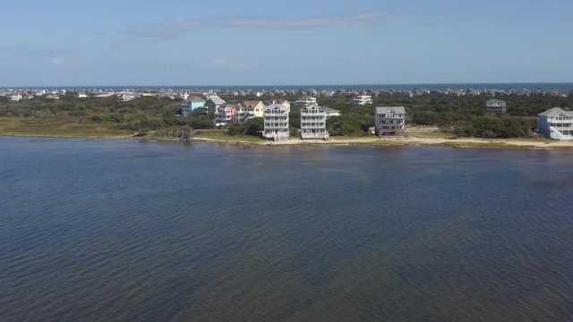129 Aerial view of fancy houses, flying above town and beach. 4k