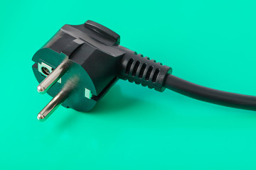 Electrical plug on green background