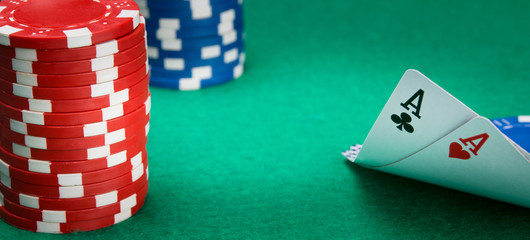 on the green table, for gambling, two ace cards are parted, on the left is a stack of chips, for playing in a casino, there is a place for an inscription