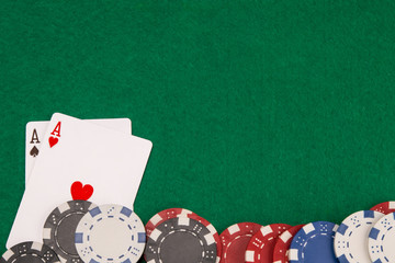 on the green table, two aces and scattered blackjack chips, on the right there is a place for the inscription