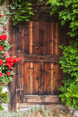 Old vintage wooden door with stairs in the Austrian city of Lofer