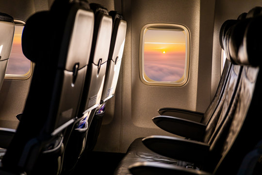 Empty Airplane Seats In The Cabin In Sunset Light