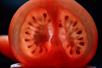 Red tomato cut in half with the texture of seeds