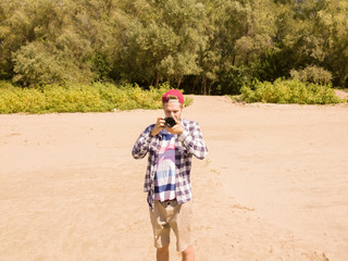 young male photographer outdoor near the river bank