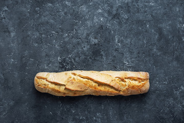 Fresh baguette dark stone background copy space top view