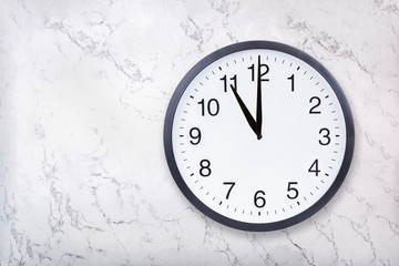 Wall clock show eleven o'clock on white marble texture. Office clock show 11pm or 11am on marble background