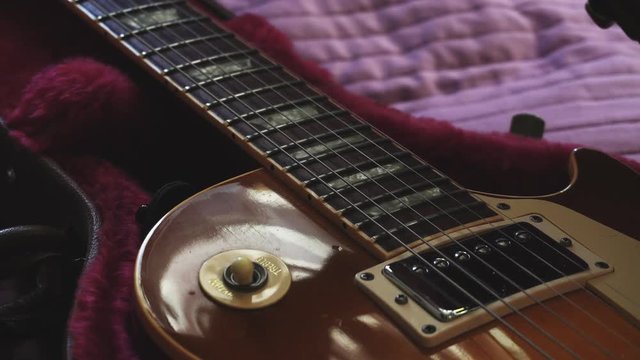 Man opening a guitar leather case. Closeup