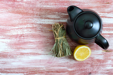 A bunch of dry lemongrass, fresh lemon, teapot. Copy space. Tea Ingredients. The culture of tea...