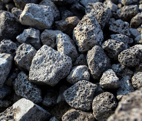 Stones on the edge of the asphalt road