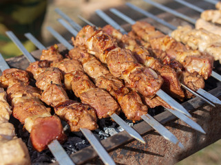 Shish kebab on skewers is fried on a brazier