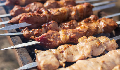 Shish kebab on skewers is fried on a brazier