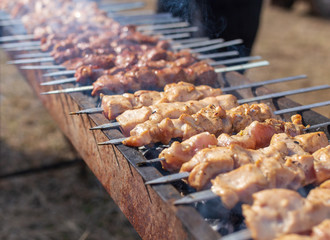 Shish kebab on skewers is fried on a brazier
