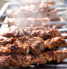 Shish kebab on skewers is fried on a brazier