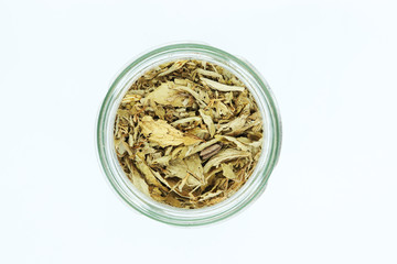 dried stevia leaves in bottle isolated on white background.