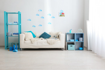 Interior of kids room with comfortable sofa