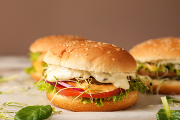 Tasty burgers on table