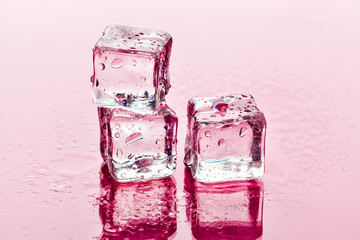 Ice cubes on pink background