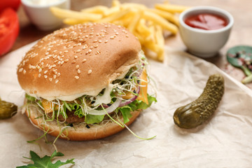 Tasty burger on table