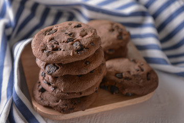 Tasty cookies with chocolate chips on board
