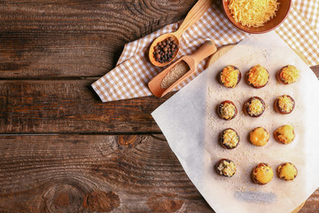 Tasty stuffed mushrooms on wooden table