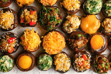 Tasty stuffed mushrooms on white background