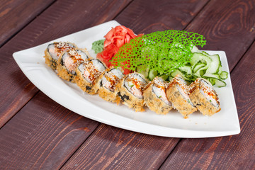 Japanese national popular cuisine. Sushi, rice and fish. Tasty, beautifully served food in a restaurant, cafe, with elements of the original design.