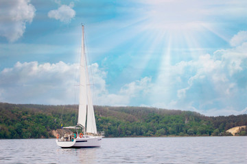 Sailboat in the sea in the sunnt day over beautiful big mountains background, luxury summer adventure, active vacation . Space for text