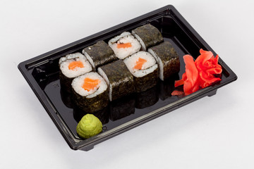 Japanese national popular cuisine. Sushi, rice and fish. Tasty, beautifully served food in a restaurant, cafe, with elements of the original design.